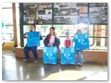 Four happy kids open their grab-bags